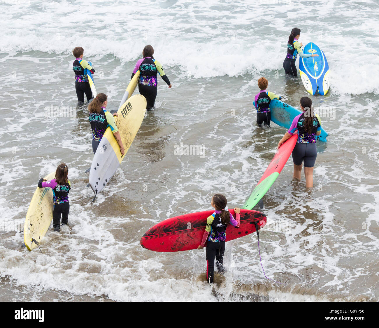 Las Palmas, Gran Canaria, Canary Islands, Spain, 30th June 2016. Weather: Surf schools are busy on the city beach in Las Palmas as Spanish schoolchildren keep active during their long summer holidays (20th June - 9th September). Credit:  Alan Dawson News/Alamy Live News Stock Photo