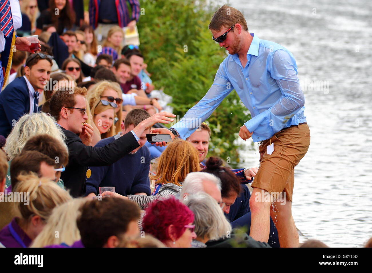 Rowers from all over the world came to the annual Henley Royal Regatta 2016. A reveller makes an unexpected dip into the river. Stock Photo