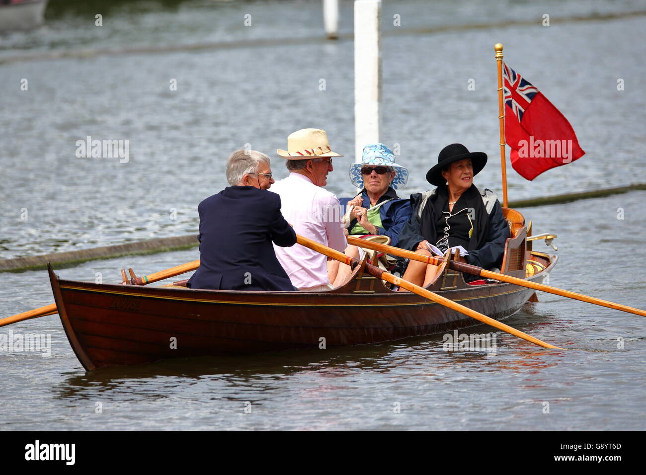 Rowers from all over the world came to the annual Henley Royal Regatta 2016. Two couples enjoy the day from their traditional rowing boat. Stock Photo