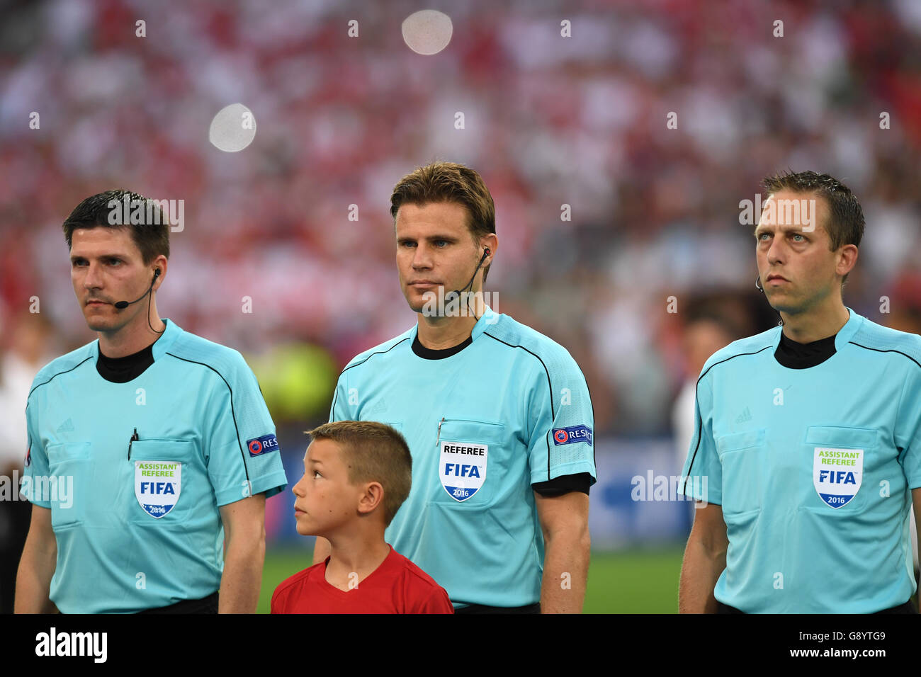Marseille, France. 30th June, 2016. Referee Felix Brych of Germany (C) and his team, assistant referee Stefan Lupp (L) of Germany, assistant referee Mark Borsch (R) of Germany before the UEFA EURO 2016 quarter final soccer match between Poland and Portugal at the Stade Velodrome in Marseille, France, 30 June 2016. Photo: Federico Gambarini/dpa/Alamy Live News Stock Photo