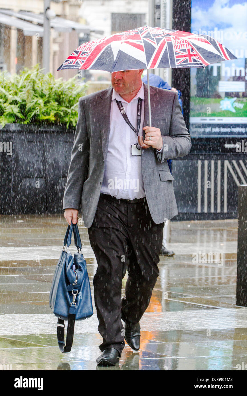 Manchester, UK. 1st July, 2016. UK Weather:  Torrential heavy downpours of rain soak shoppers in Manchester City Centre.  The unsettled weather across the north west of England caught shoppers by surprise with heavy outbursts of rain this afternoon.  Some were prepared but others use alternative techniques to shelter.  Credit:  Cernan Elias/Alamy Live News Stock Photo