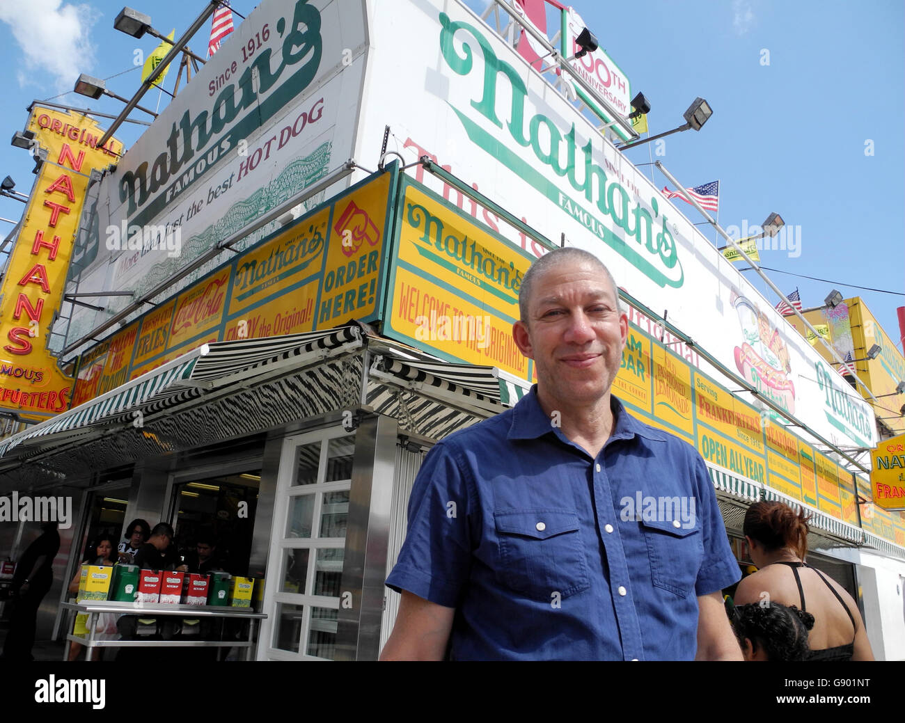 New York, US. 29th June, 2016. Lloyd Handwerker, grandson of Nathan Handwerker, founder of 'Nathan's', standing in front of 'Nathan's' restaurant in Coney Island in New York, US, 29 June 2016. The restaurant famous for simple fast food snack celebrates its 100th anniversary this year. PHOTO: JOHANNES SCHMITT-TEGGE/dpa/Alamy Live News Stock Photo