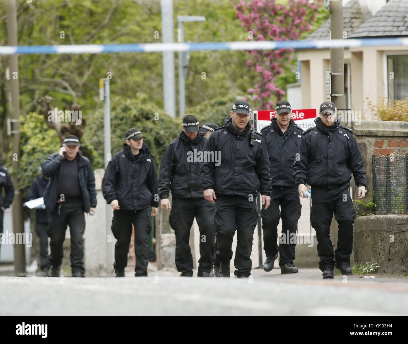 Police officers at the scene on Old Dalkeith Road in Edinburgh where a woman was knocked down and killed by a car being chased by police. Stock Photo
