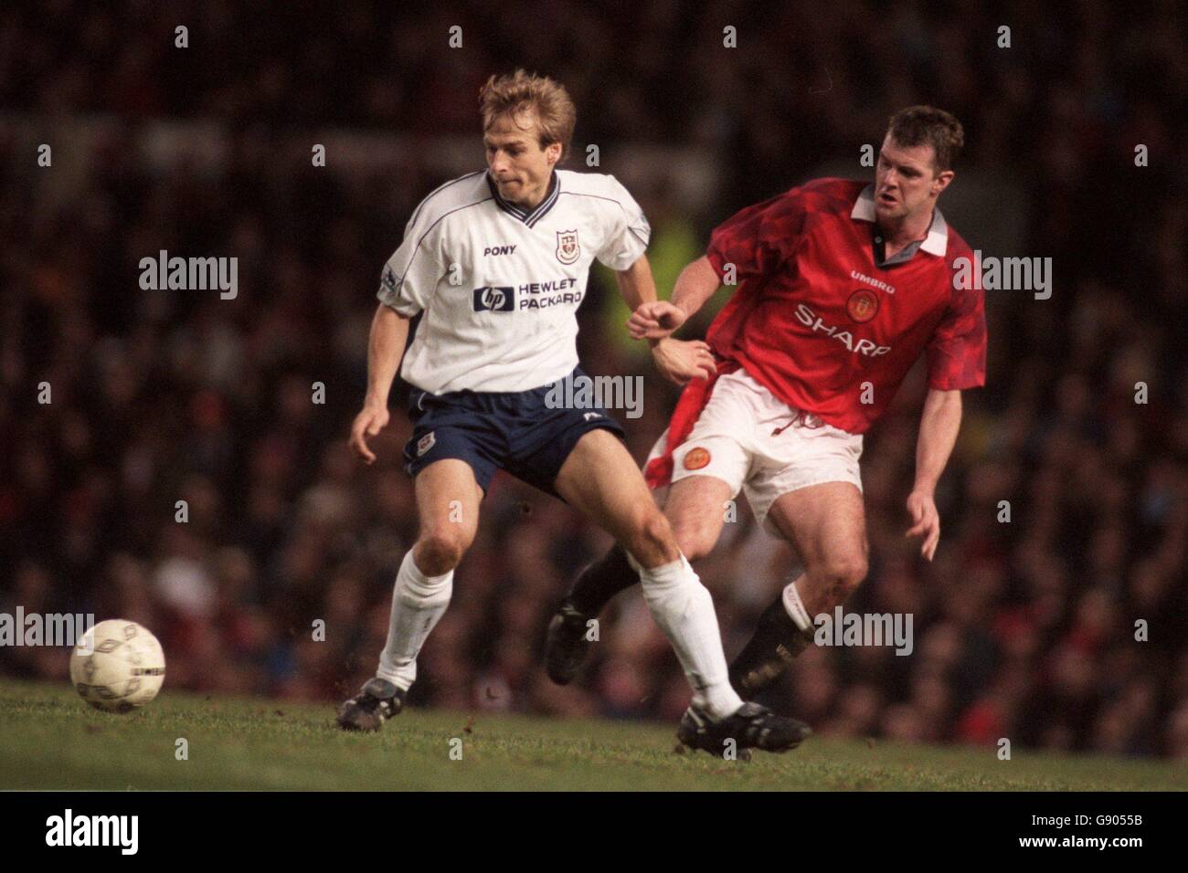 Jurgen Klinsmann of Tottenham Hotspur (left) shields the ball from Gary Pallister of Manchester United (right) Stock Photo