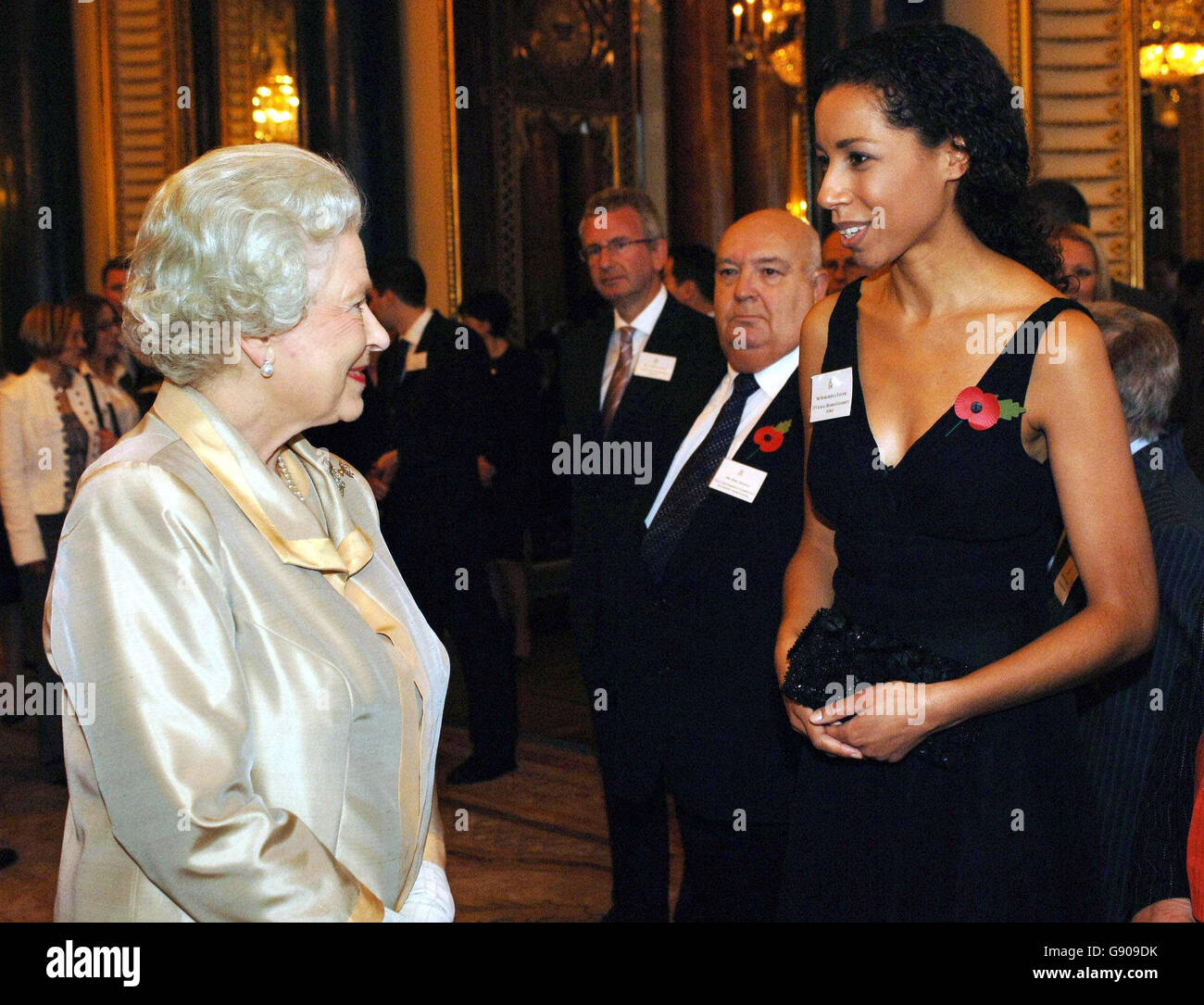 Queen Elizabeth II meets radio and television presenter Margherita Taylor, who volunteers fpr the Prince's Trust during a special reception at Buckingham Palace in recognition of guests work as volunteers, Thursday 3 November 2005. Among the celebrity guests was model Nell McAndrew and Coronation Street star Ryan Thomas, who plays Jason Grimshaw in the hit soap. McAndrew, who was wearing a skin-tight black dress with white polka dots, met both the Queen and the Duke of Edinburgh. She raises money and supports several charities, including Cancer Research UK and often takes part in races for Stock Photo