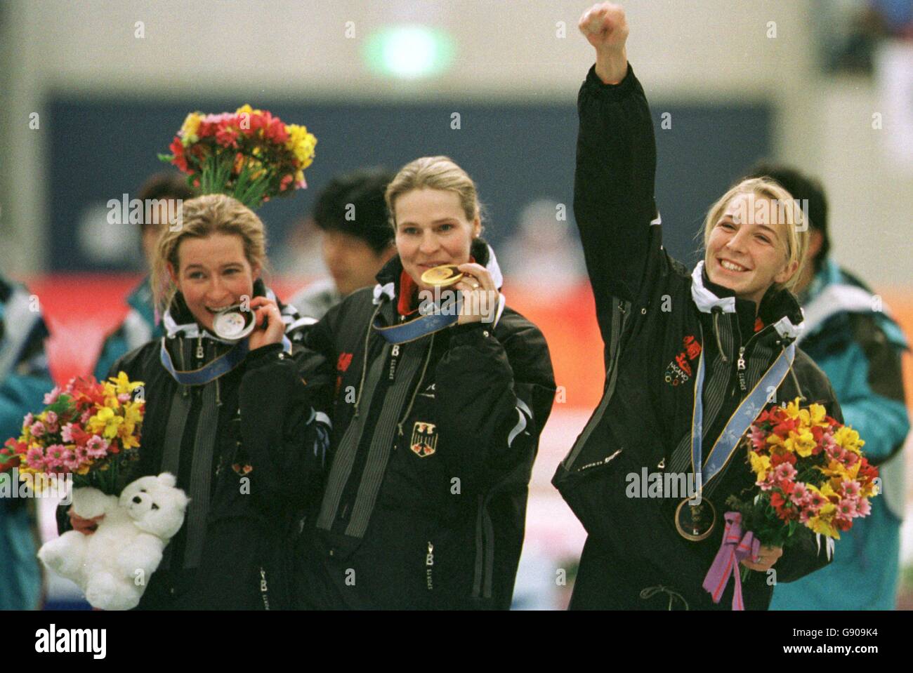 Gunda Niemann Stirnemann (C), Claudia Pechstein (L), and Anna Friesinger (R), Germany, celebrate their success at the Speed Skating competion. Stock Photo