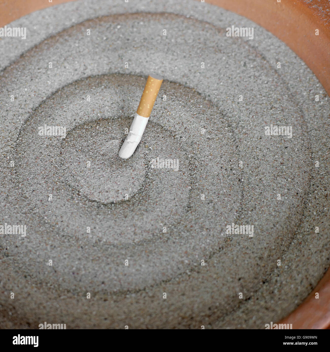 smoked cigarettes in sand ashtray Stock Photo Alamy