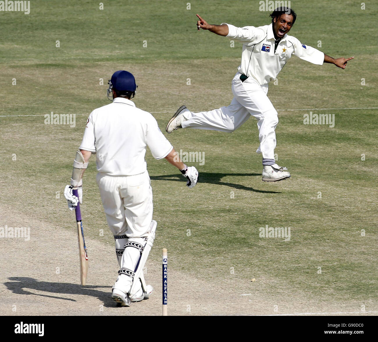 Pakistan's Shoaib Akhtar (R) celebrates clean bowling England's Ashley Giles during the fifth day of the first Test match at the Multan Cricket Stadium in Multan, Pakistan, Wednesday November 16, 2005. See PA story CRICKET England. PRESS ASSOCIATION Photo. Photo credit should read: Gareth Copley/PA. ***- NO MOBILE PHONE USE*** Stock Photo