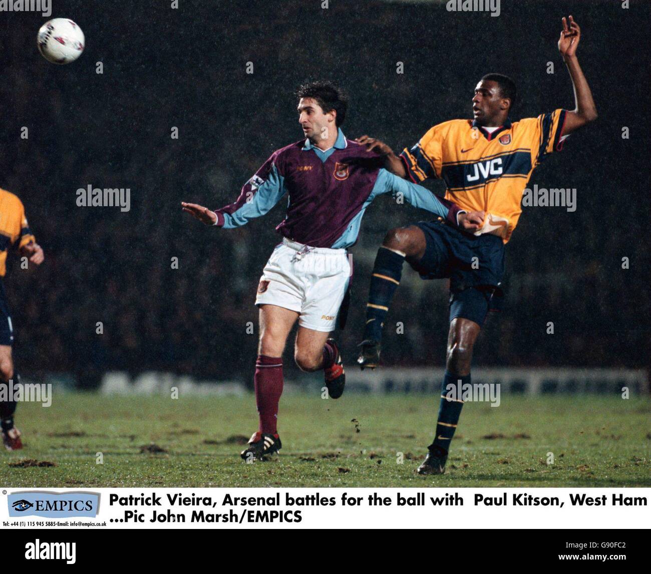 Patrick Vieira of Arsenal (right) knocks the ball away from Paul Kitson of West Ham United (left) Stock Photo