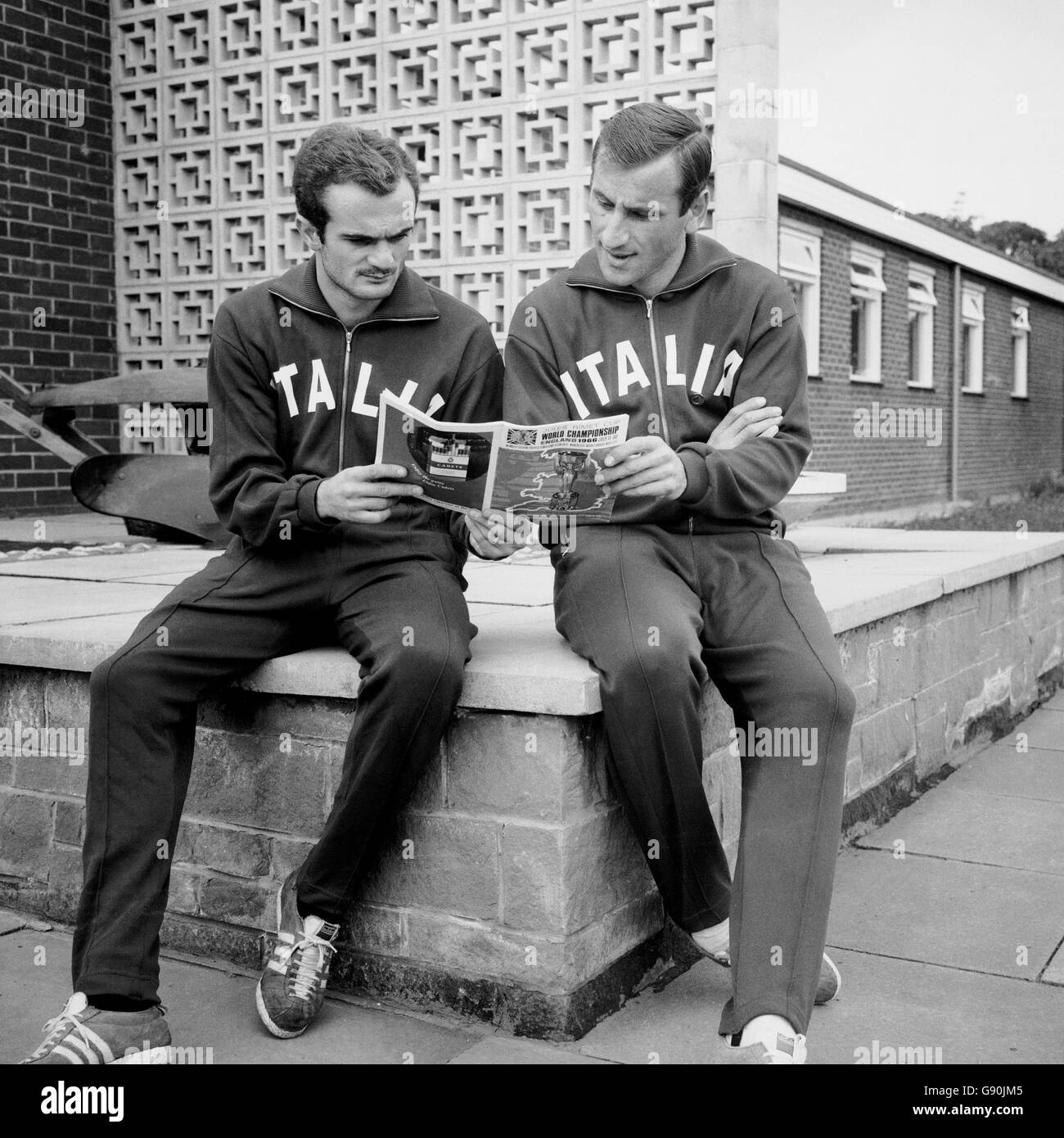 Italy's Sandro Mazzola (l) and Paolo Barison (r) read the newspaper reports after they both scored to beat Chile 2-0 the previous day. Stock Photo