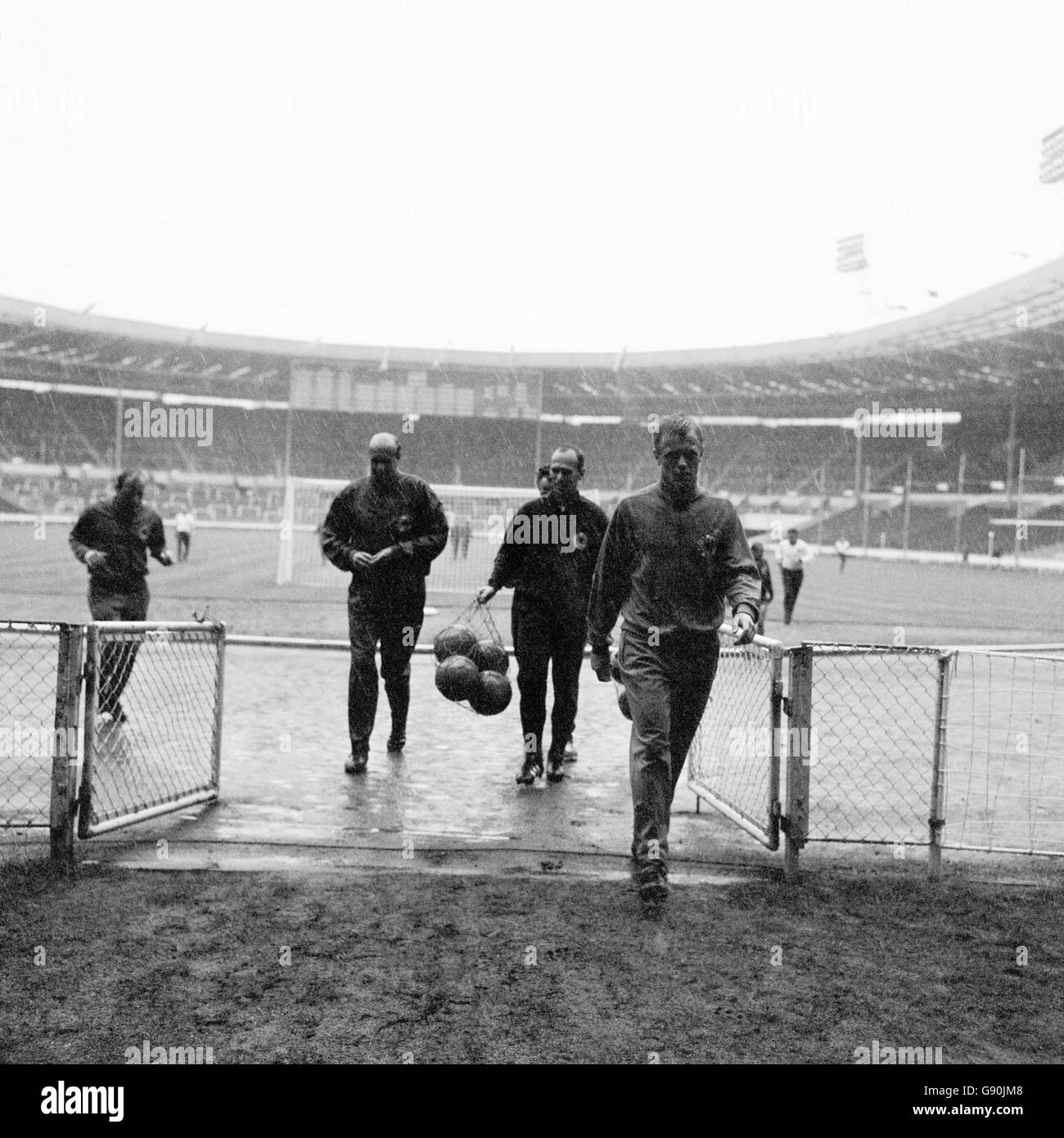 West Germany players run off the pitch as a thunder storm breaks out above. They were training ahead of the World Cup Final against England the next day. Stock Photo