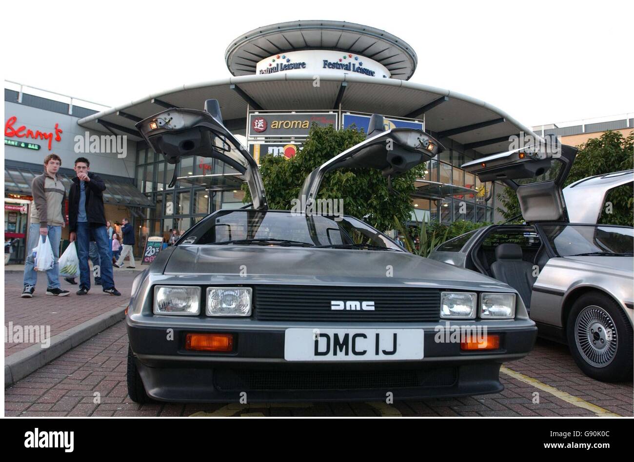 VIsitors take a look at the Delorean cars on display at Basildon UCI cinema, to mark a special showing of the Back to the Future films trilogy. In a rare event, more than 20 of the famous cars were bought together by the Delorean Owners Club. Stock Photo