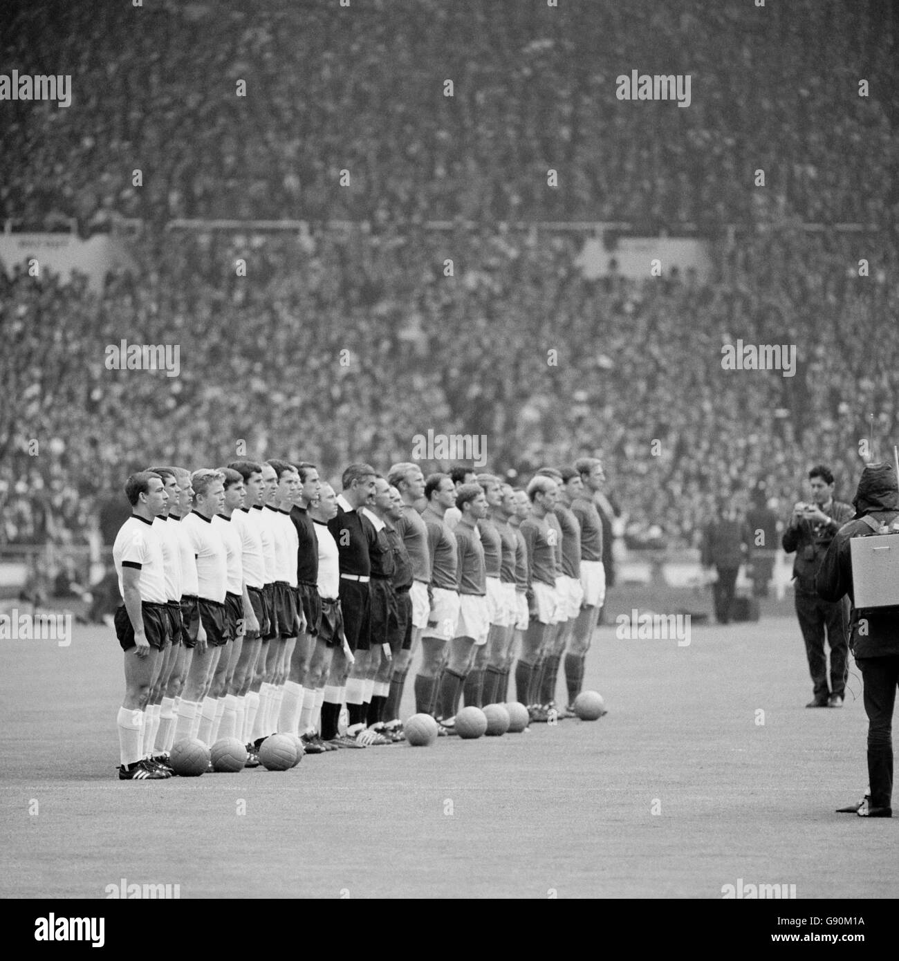 The two teams line up before the match: (l-r) West Germany's Horst-Dieter Hottges, Wolfgang Overath, Siggi Held, Helmut Haller, Wolfgang Weber, Lothar Emmerich, Willi Schulz, Franz Beckenbauer, Karl-Heinz Schnellinger, Hans Tilkowski and Uwe Seeler, linesman Tofik Bakhramov, referee Gottfried Dienst, linesman Karol Galba, England's Bobby Moore, George Cohen, Alan Ball, Gordon Banks, Roger Hunt, Ray Wilson, Nobby Stiles, Bobby Charlton, Geoff Hurst, Martin Peters, Jack Charlton Stock Photo