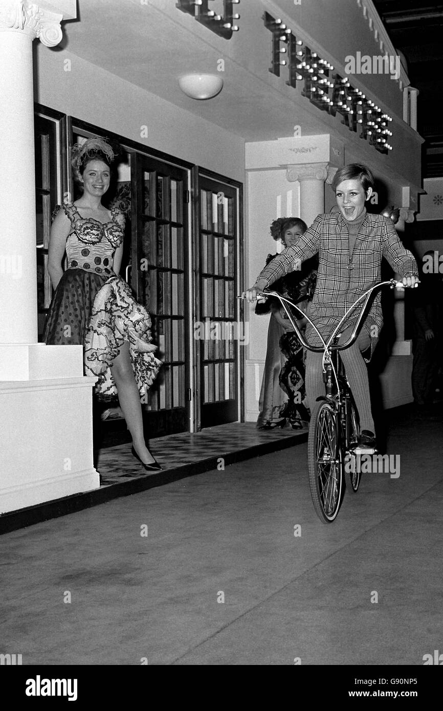 Seventeen-year-old model Twiggy (Lesley Hornby) has the mind-my-bike look as she tours the Daily Mail Ideal Home Exhibition at Olympia. Stock Photo