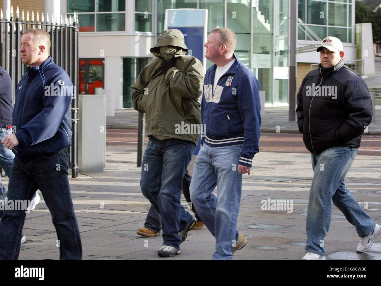 Supporters of Andre Shoukri arrive at Belfast magistrates court, Saturday 12th November 2005. Police in Belfast today mounted a huge security operation outside the city's magistrates' courts as supporters of leading loyalist Andre Shoukri gathered in a show of solidarity with him. The 28-year-old Ulster Defence Association brigadier appeared at Laganside Courts Complex on blackmail, intimidation and money-laundering charges. Supporters, many of them wearing hooded tops, baseball caps and scarves, gathered at the complex. See PA story ULSTER UDA. PRESS ASSOCIATION Photo. Photo credit should Stock Photo