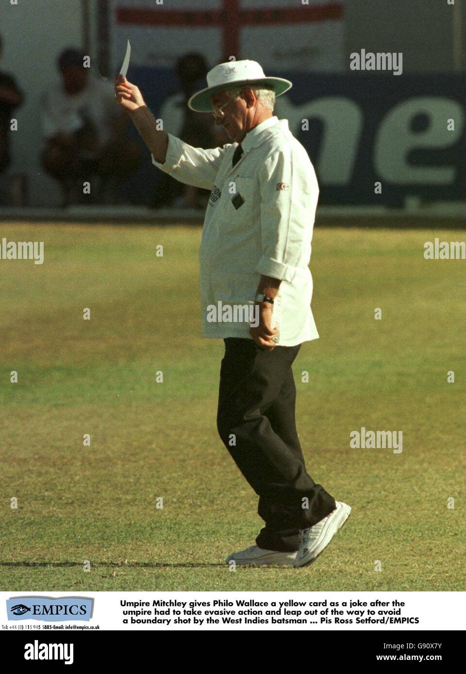 Umpire Cyril Mitchley gives West Indies batsman Philo Wallace a yellow card as a joke after the umpire had to take evasive action and leap out of the way to avoid a boundary shot by the West Indian Stock Photo