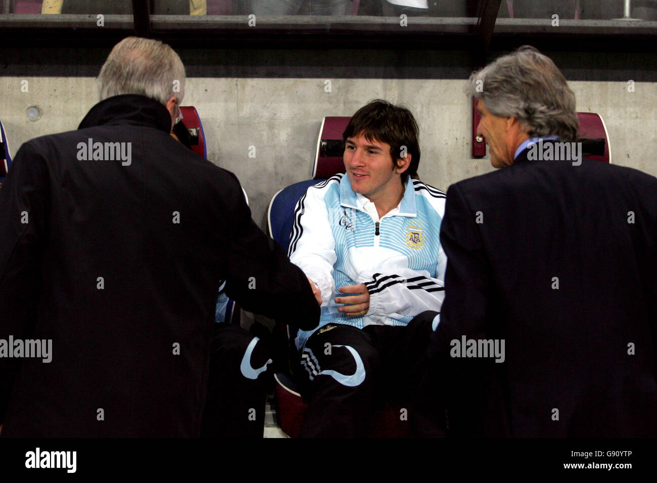 Argentina's Lionel Messi (c) shakes hands with England coach Sven Goran Eriksson (l) as Argentina coach Jose Nestor Pekermann (r) looks on Stock Photo