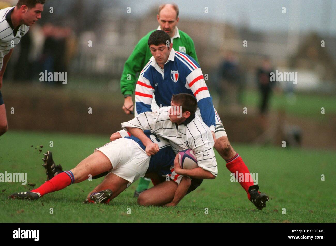 Scotland's Scott Murray (R) is tackled by France's Aubin Hueber (L) and Marc Raynaud (Top) Stock Photo