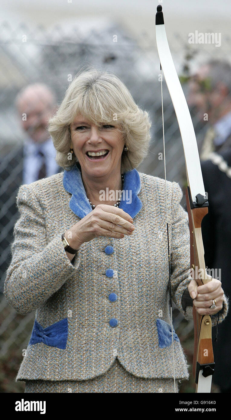 The Duchess of Cornwall laughs after trying her hand at archery, during