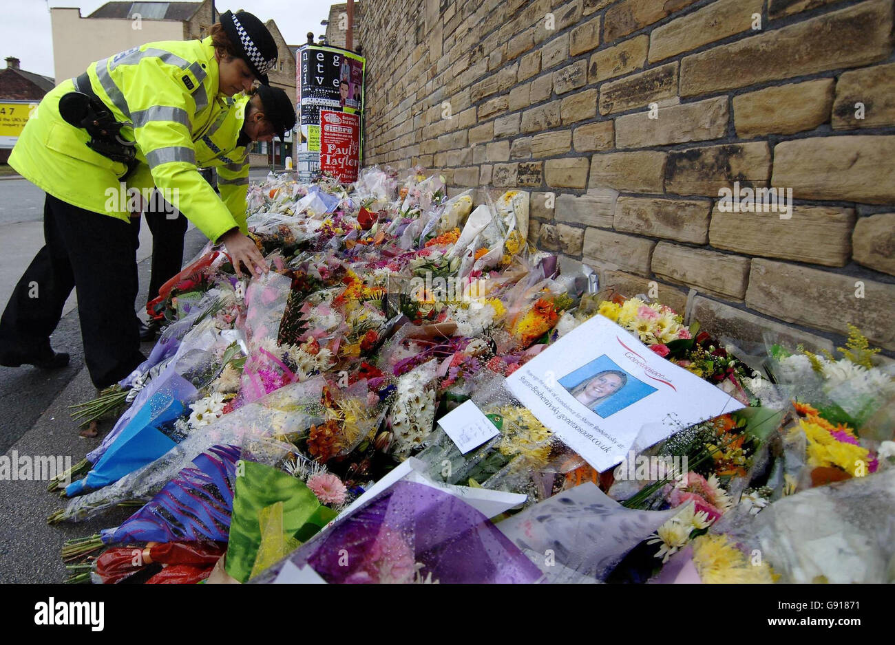 Hundred of floral tributes at the scene of the murder of Pc Sharon Beshenivsky, Sunday November 27, 2005. Detectives were today questioning a a 19-year-old man over the murder of Pc Beshenivsky and the attempted murder of her colleague Pc Teresa Milburn. Yusuf Jama - one of three men police named as suspects earlier this week - was arrested in Birmingham, West Yorkshire Police said. See PA Story POLICE Officer. PRESS ASSOCIATION Photo. Photo credit should read: John Giles/PA. Stock Photo