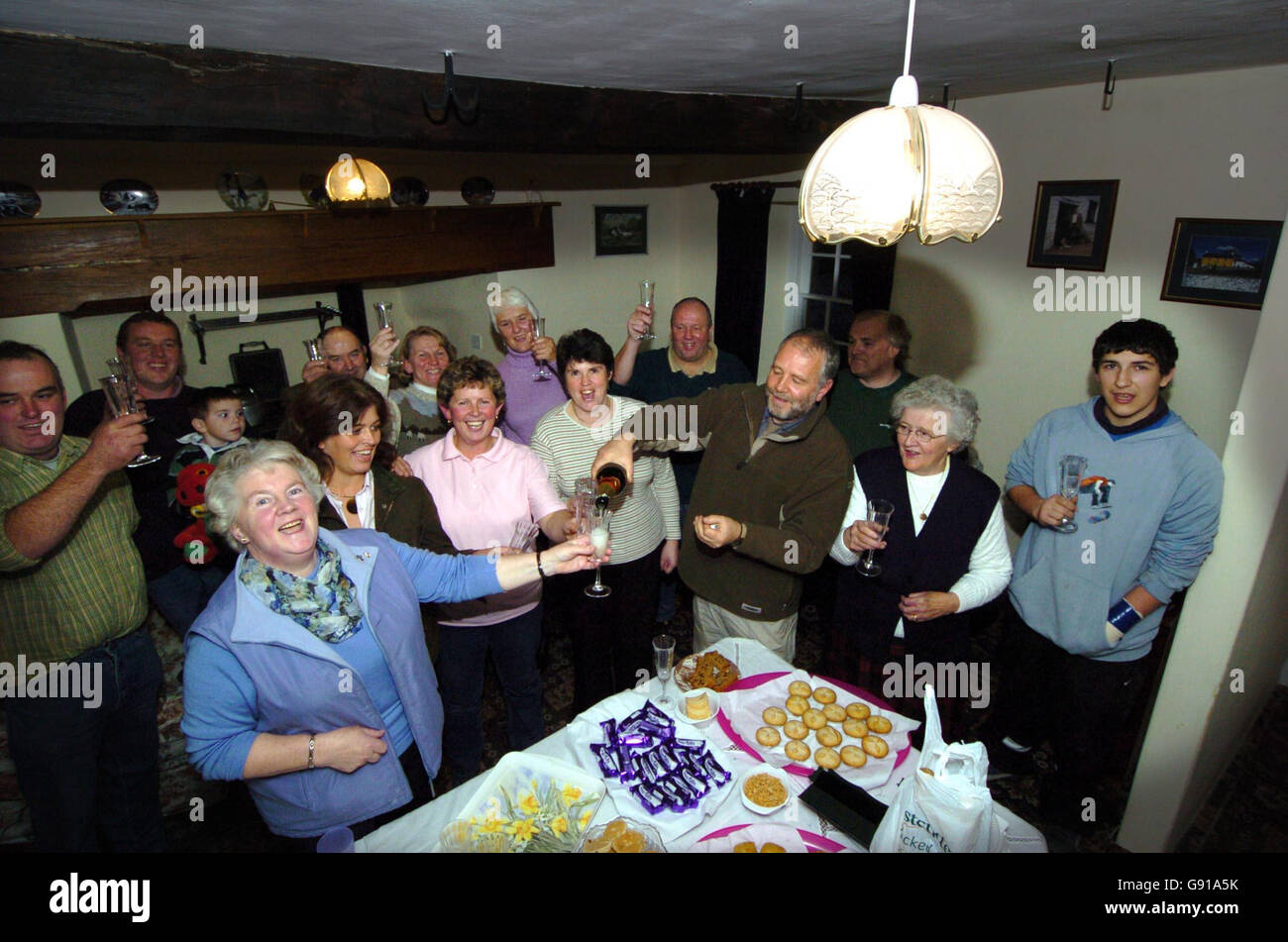 Farming neighbours and friends gather at Jennet and Jean Llewllyn's Berthlwyd farm in the Upper Neath Valley to celebrate as the last four farms are connected to the national grid, Thursday 1st December 2005. picture. Picture credit should read: David Jones/PA Stock Photo