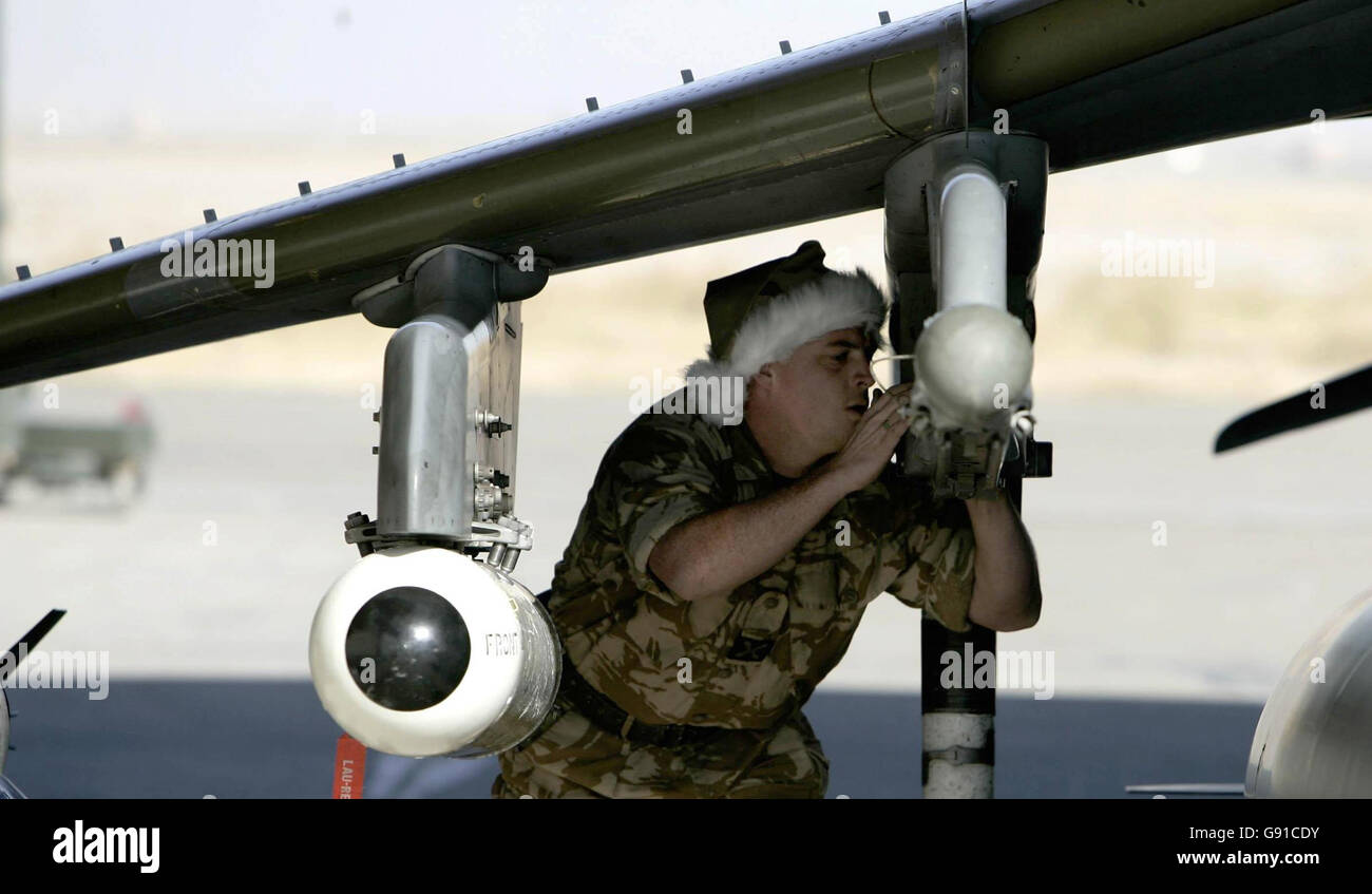 RAF ground crew check bombs on an RAF Harrier after it has been out on ...