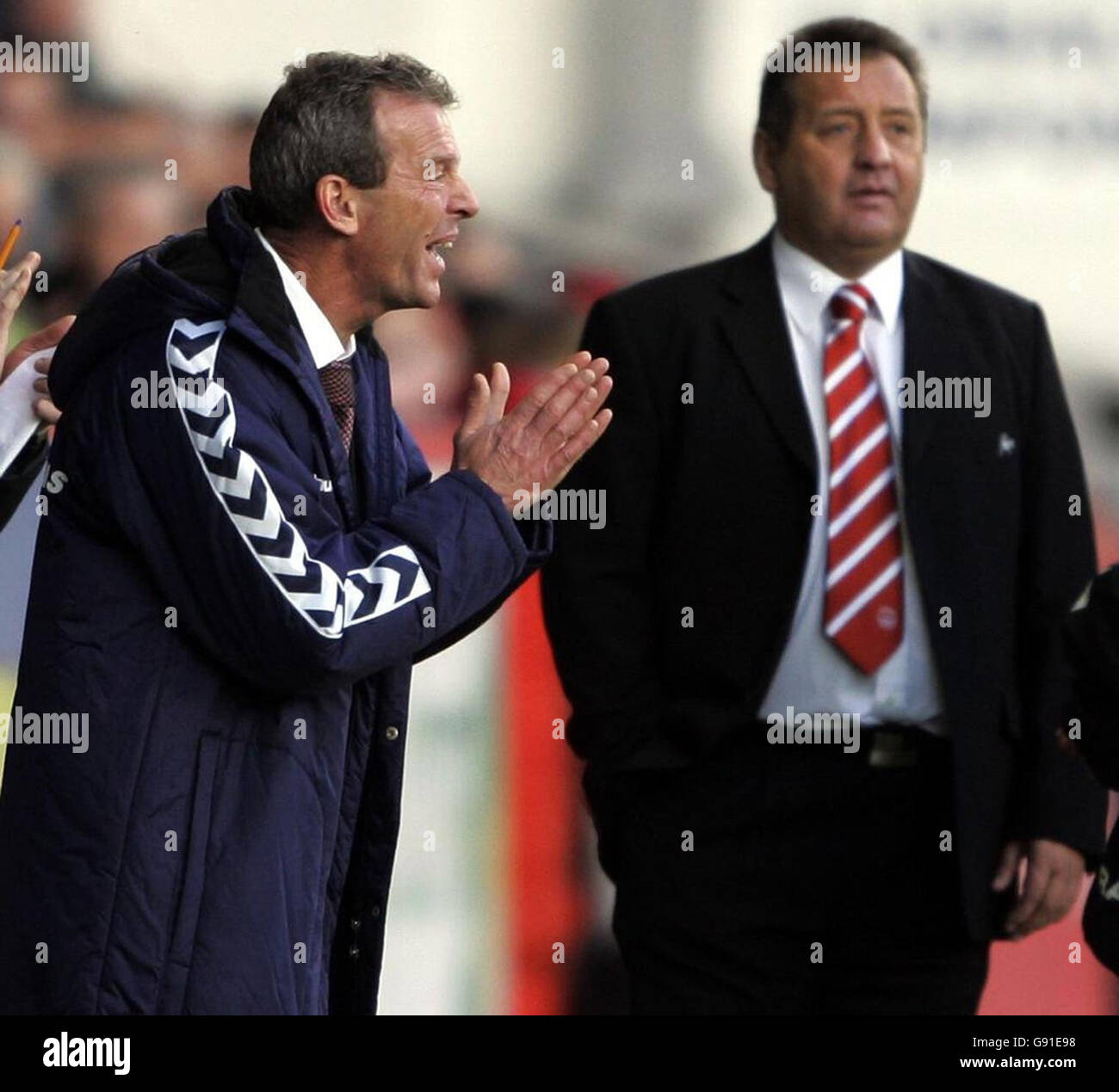 Hearts new manager Graham Rix (L) cheers his team as Aberdeen manager Jimmy Calderwood looks on during the Bank of Scotland Premier League match at Pittodrie Stadium, Aberdeen, Sunday November 20, 2005. PRESS ASSOCIATION Photo. Photo credit should read: Andrew Milligan/PA. **EDITORIAL USE ONLY** Stock Photo