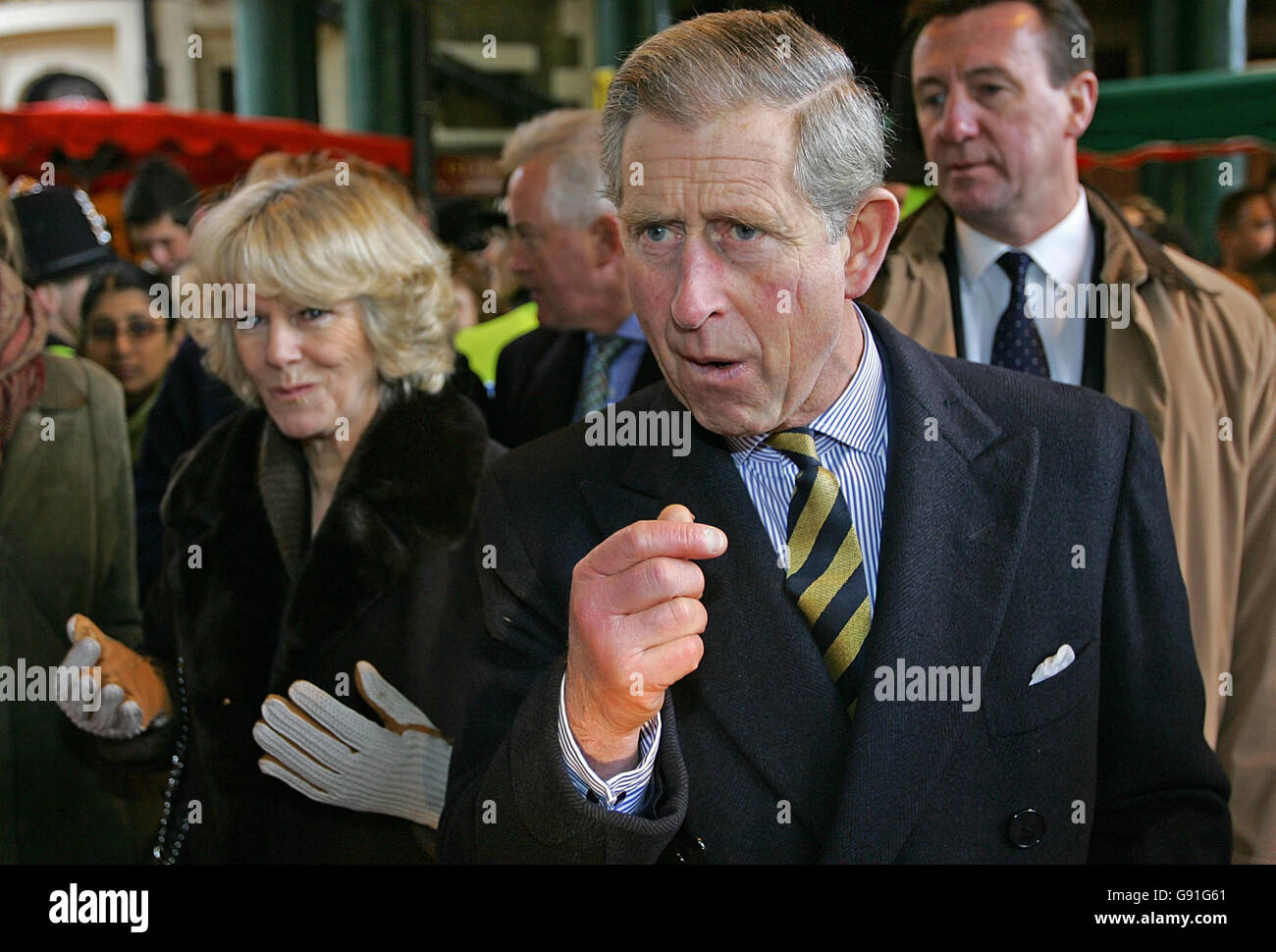 The Prince of Wales (right) and The Duchess of Cornwall tries out fudge from a farm stall at the Borough market in central London, Friday 25 November 2005. See PA Story ROYAL Market. PRESS ASSOCIATION Photo. Photo credit should read: Odd Andersen/PA/WPA Pool/AFP Stock Photo
