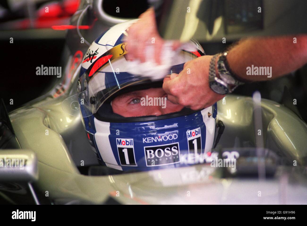 Formula One - Argentina Grand Prix - Qualifying. David Coulthard has the spray wiped from his visor Stock Photo