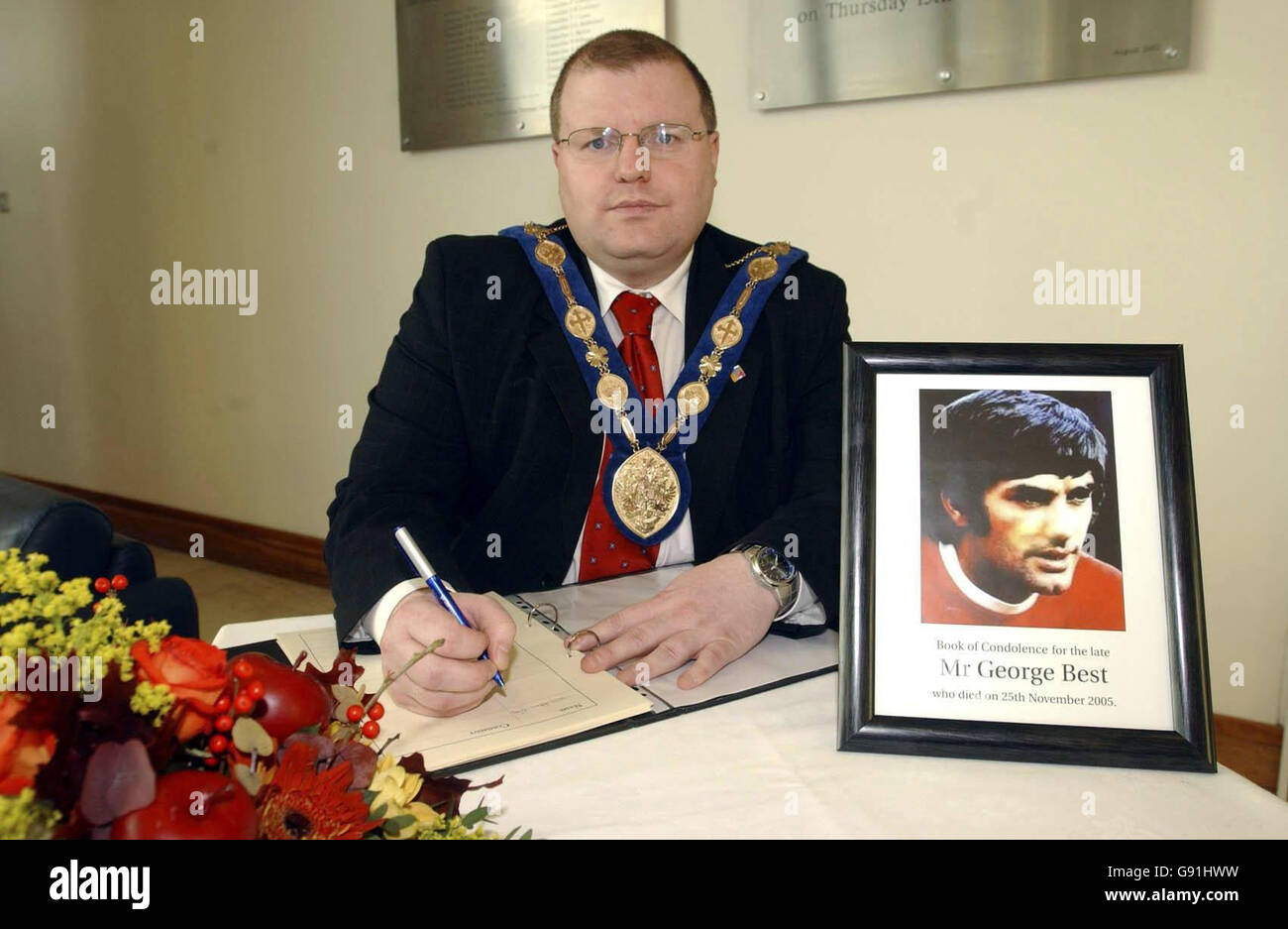 Mayor of Lisburn City Council Jonathan Calvert signs the book of condolence for footballing legend George Best at Lagan Valley Island Civic Centre where the book has been opened to the public. See PA story DEATH Best. PRESS ASSOCIATION Photo. Photo credit should read: John Harrison/Harrison Photography/PA. Stock Photo