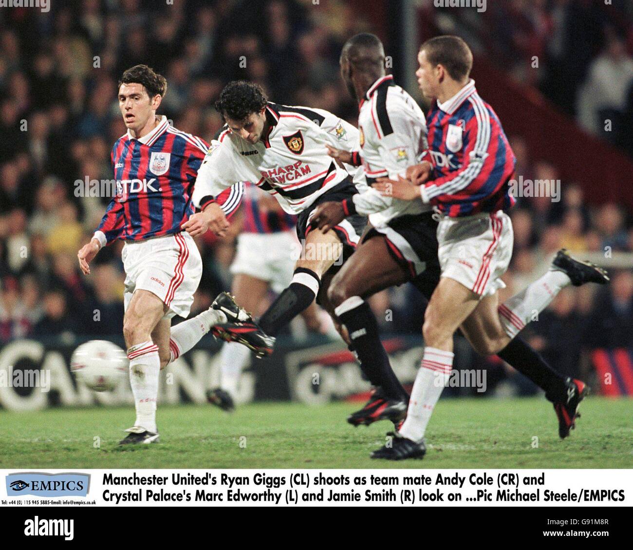 Manchester United's Ryan Giggs (CL) shoots as team mate Andy Cole (CR) and Crystal Palace's Marc Edworthy (L) and Jamie Smith (R) look on Stock Photo