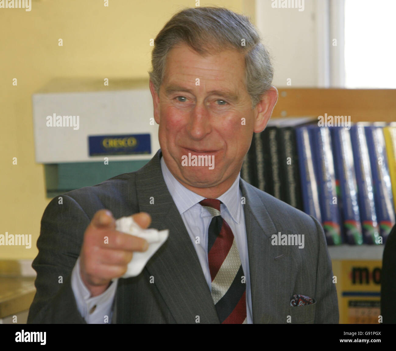 The Prince of Wales smiles after tasting some green tomato chutney during a visit to Hotwells Primary School, Bristol, Monday December 12, 2005. The Prince today visited the pioneering Bristol primary school which produces its own organic meals. The school encourages children to grow their own fruit and vegetables in the school's garden. These fresh, home-made goodies are then used as ingredients for the youngsters' school dinners. See PA story ROYAL Charles. PRESS ASSOCIATION Photo. Photo credit should read: Tim Ockenden/PA. Stock Photo