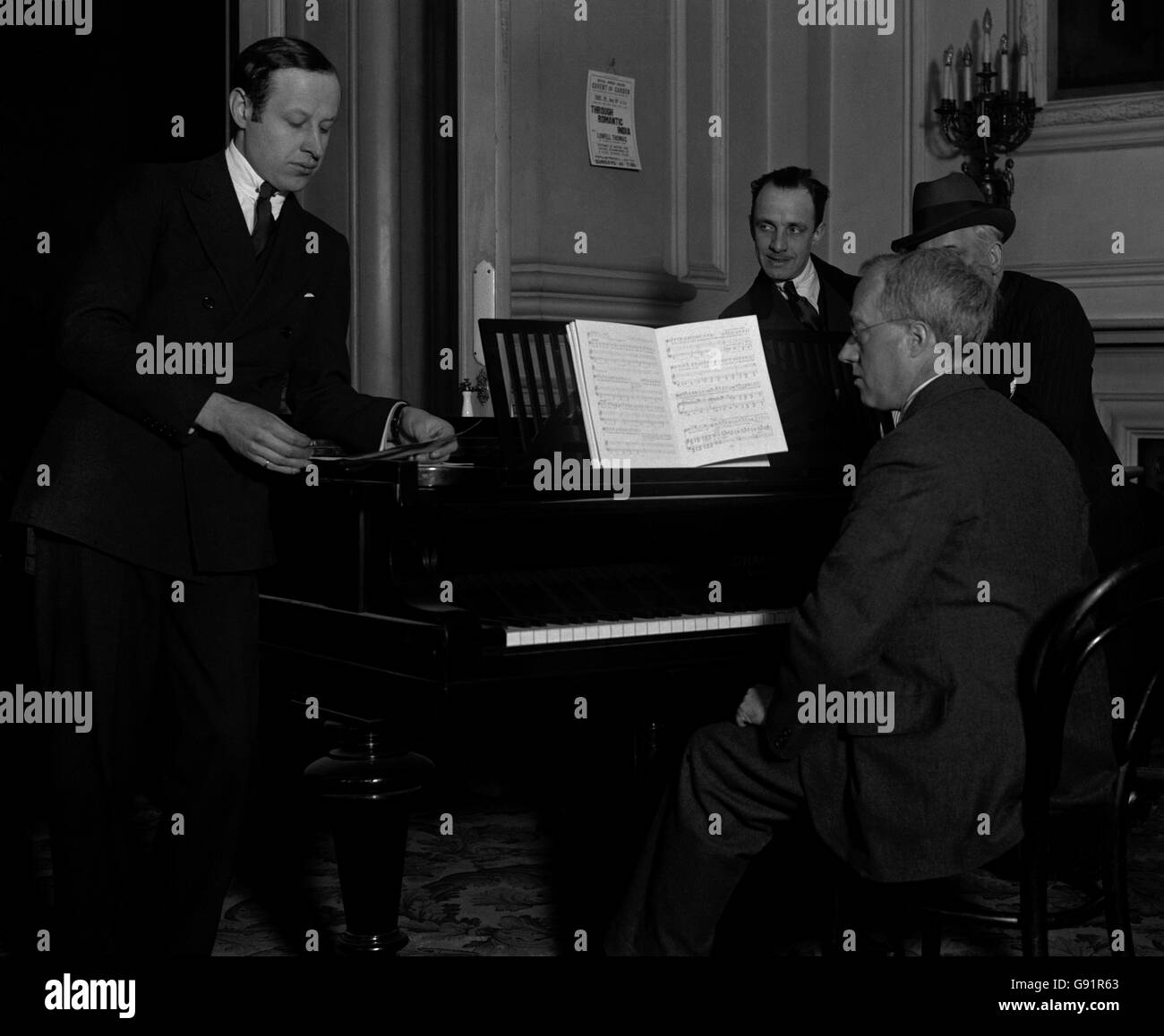 Preparing 'The Perfect Fool', by the British National Opera Company - Covent Garden Theatre. Gustave Holst, the composer, sitting at the piano, and Eugene Goossens, the conductor, looking on. Stock Photo