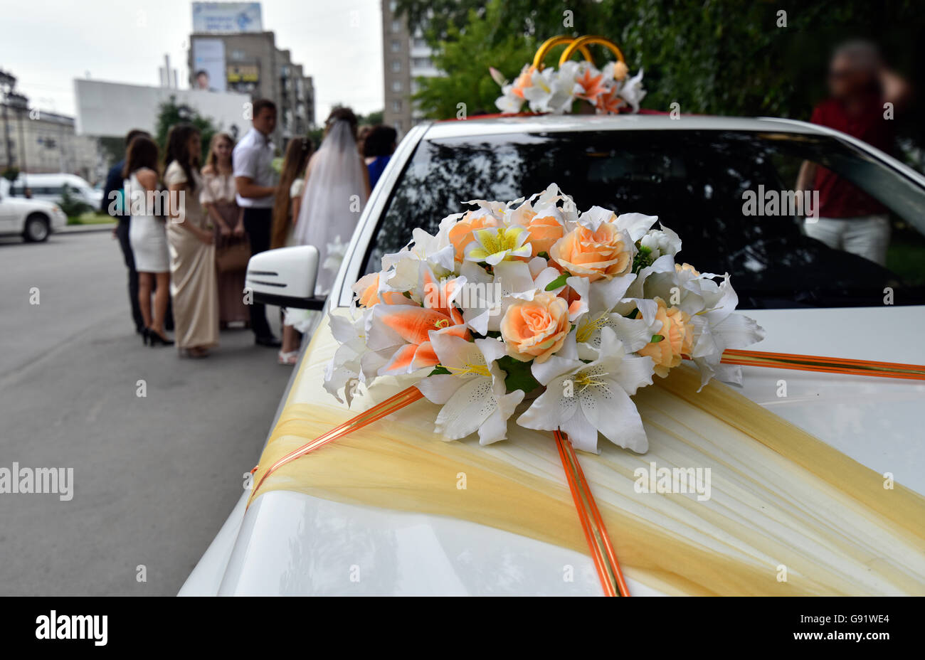 Wedding car with ribbons and flowers hi-res stock photography and