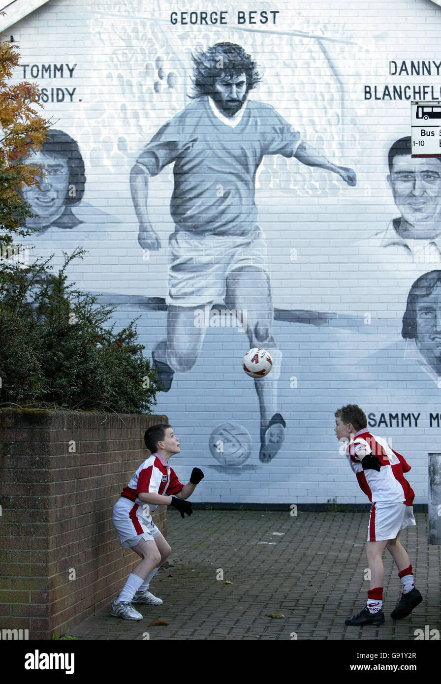 Eleven-year-olds William McKnight (left) and Ryan Strachan (right) from George Best Primary school, Nettlefield in East Belfast, play football beside a mural to the legendary footballer near the school, Thursday November 24, 2005. Mr Best is 'coming to the end of the long road of his ill-health', his doctor. Professor Roger Williams warned that Best, 59, could die at any time. See PA story HEALTH Best. PRESS ASSOCIATION Photo. Photo credit should read: Paul Faith/PA Stock Photo