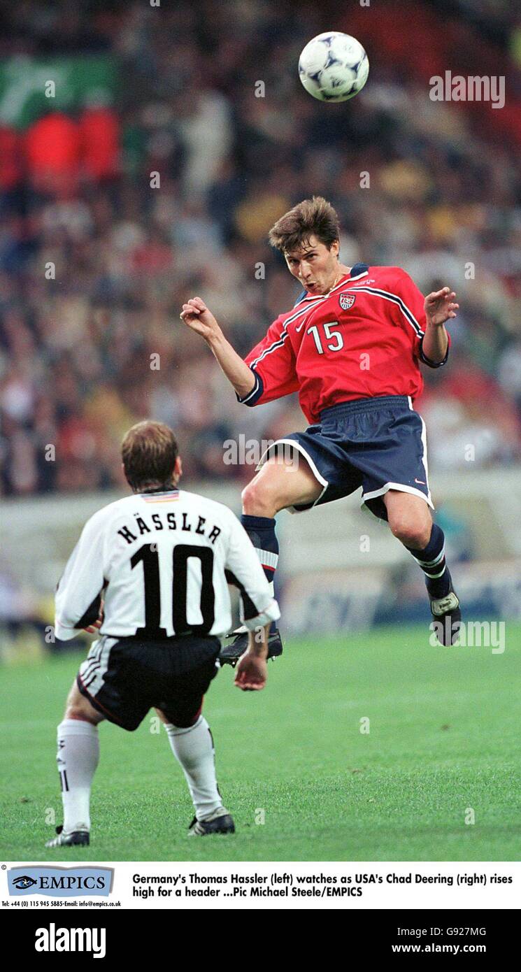 Soccer - World Cup France 98 - Group F - Germany v USA. Germany's Thomas Hassler (left) watches as USA's Chad Deering (right) rises high for a header Stock Photo