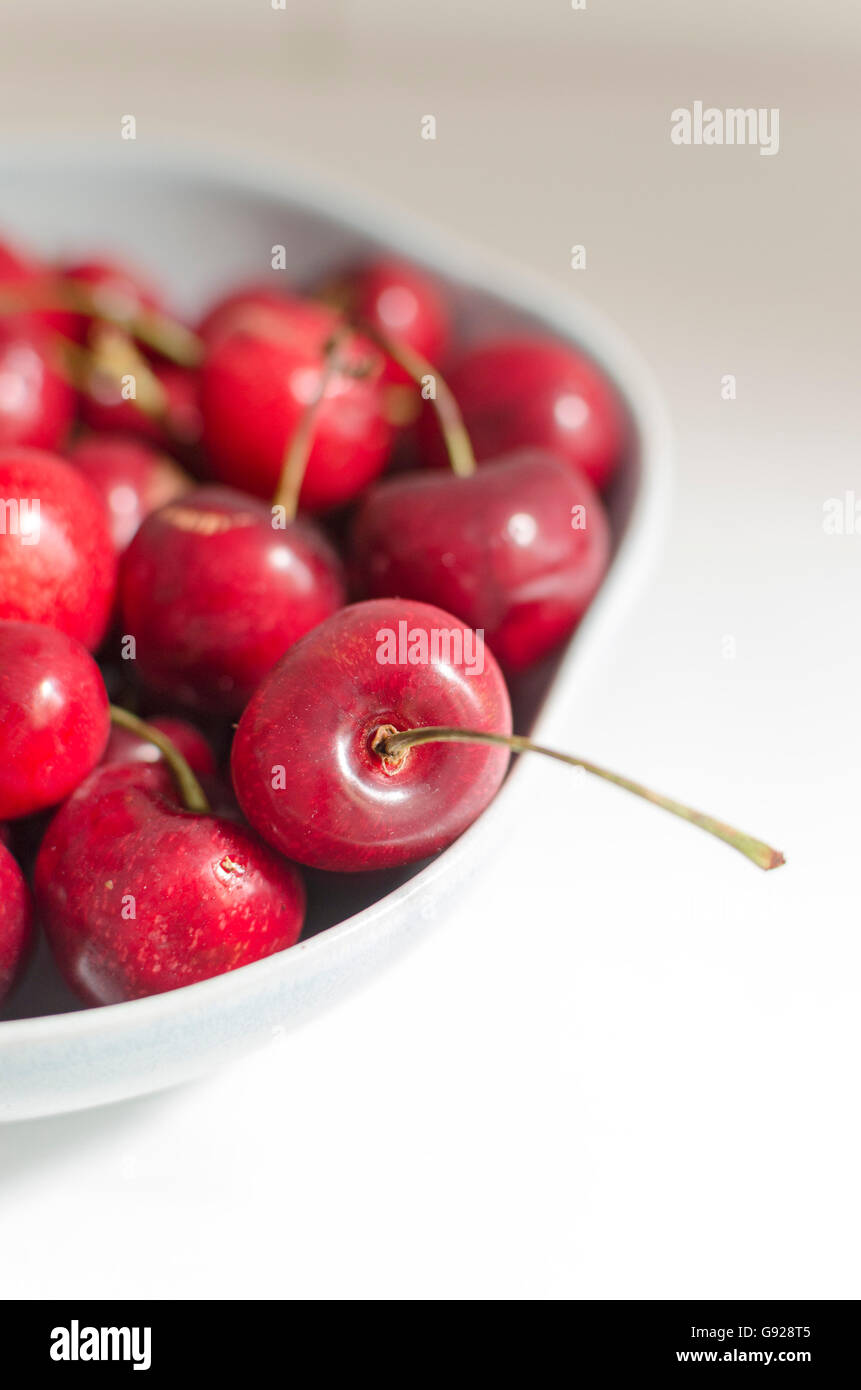 Bowl of fresh red cherries on white background Stock Photo