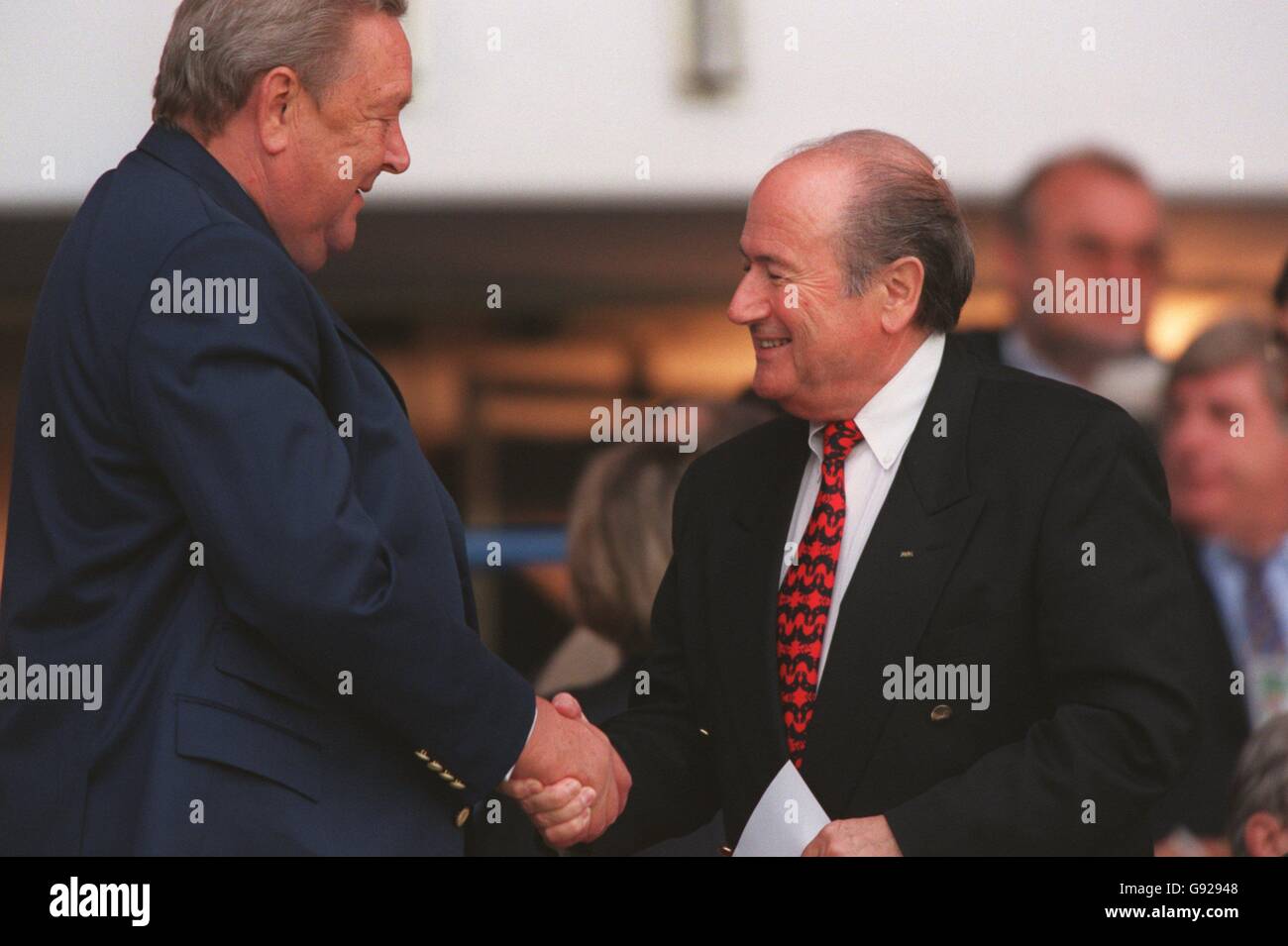 UEFA President Lennart Johansson (left) shakes hands with FIFA President Sepp Blatter (right) Stock Photo