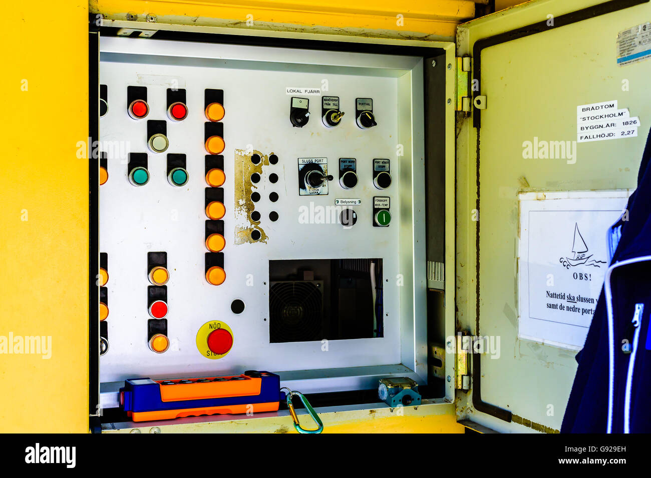 Bradtom, Sweden - June 20, 2016: Open control panel for the canal locks. Buttons and switches on panel. Remote control in orange Stock Photo