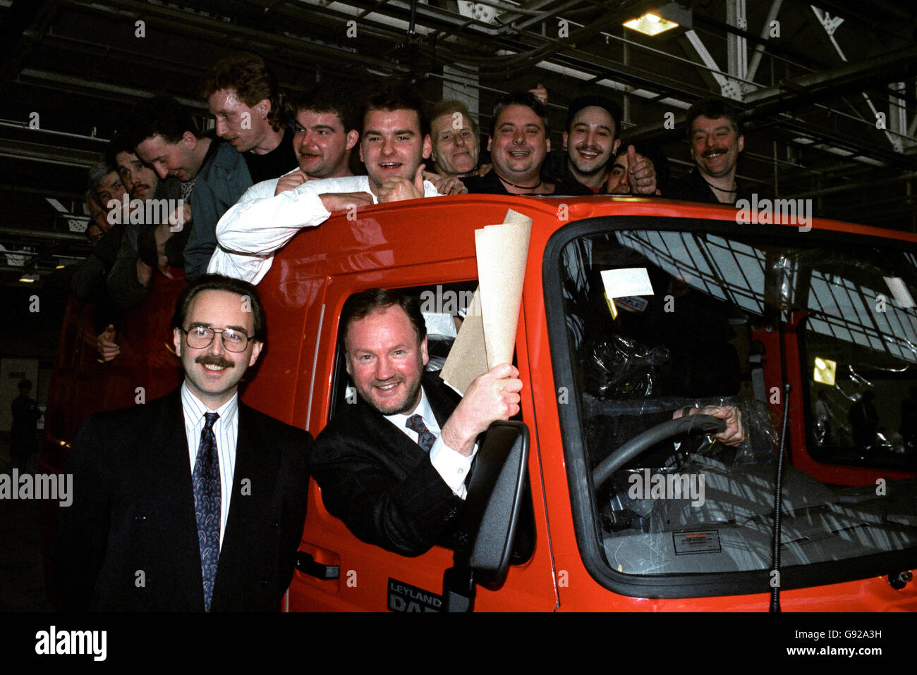 Allan Amey, the managing director & Chief Executive of Leyland-Daf vans with David Duggins (L) of the receivers with some jubilant work force. Stock Photo