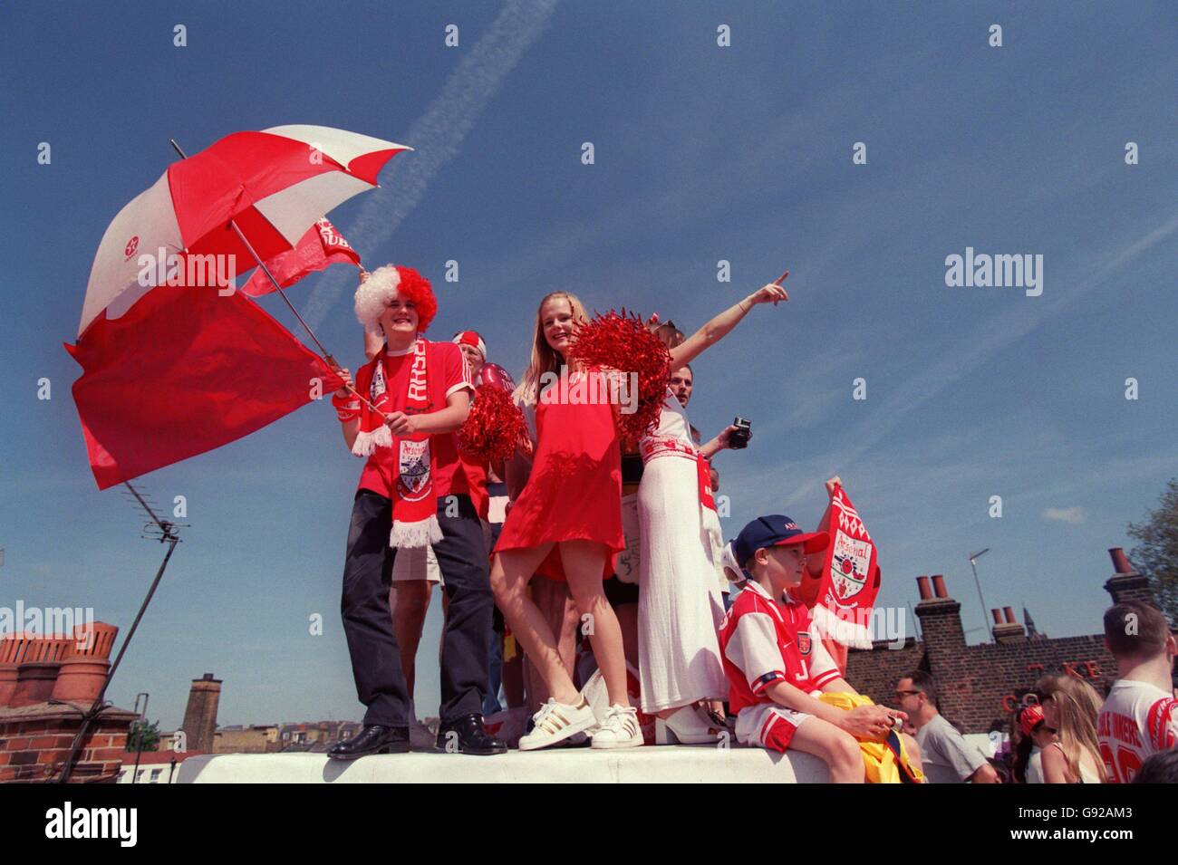 Arsenal's fans lead their team's celebrations on a rooftop opposite ...