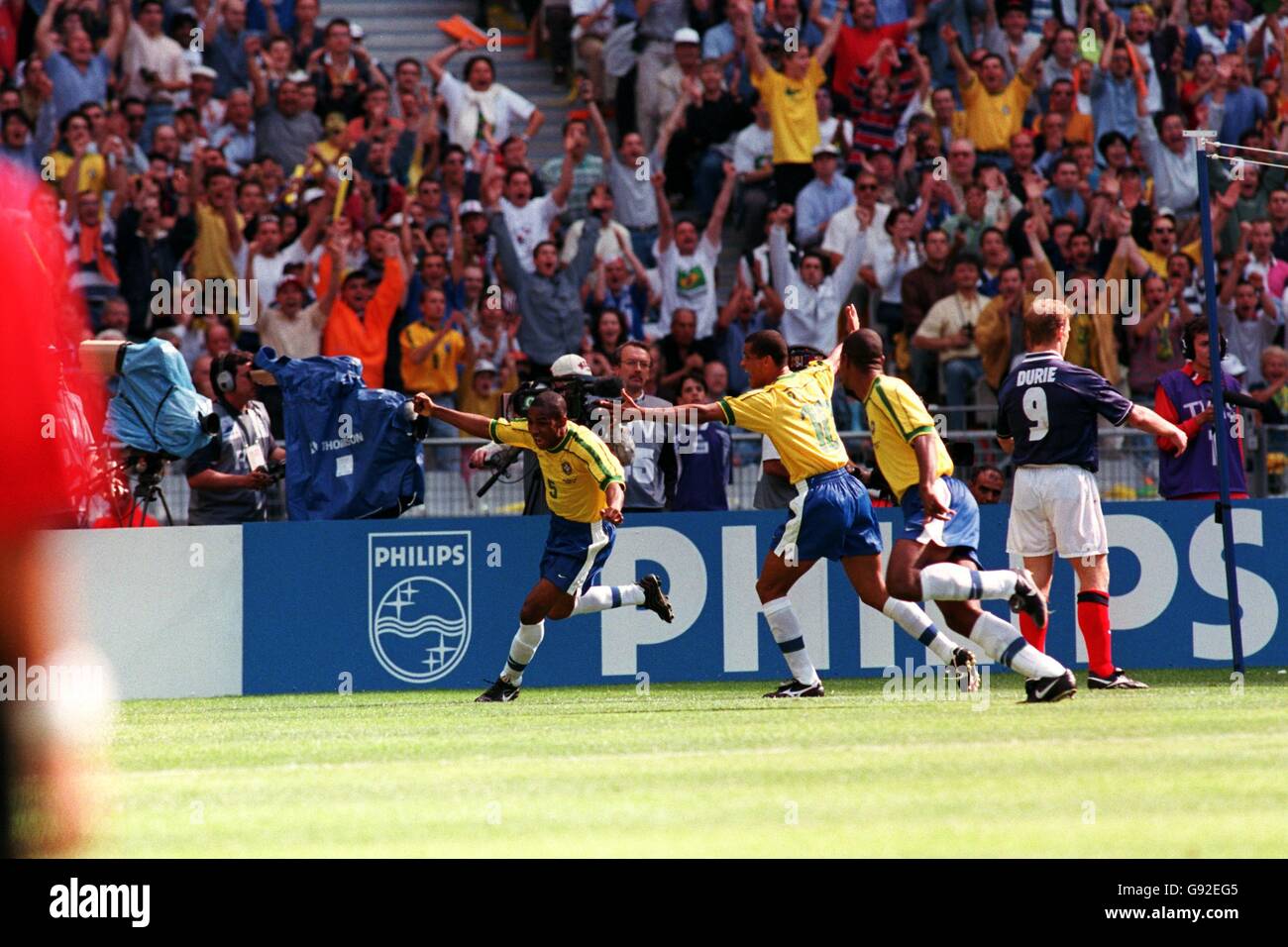 Cesar Sampaio of Brazil (left) celebrates scoring the opening goal of the World Cup with his teammates Stock Photo