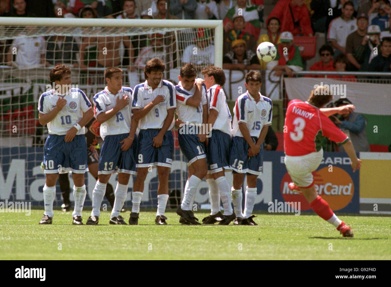 Trifon Ivanov of Bulgaria (right) curls a free kick around the Paraguay defensive wall Stock Photo