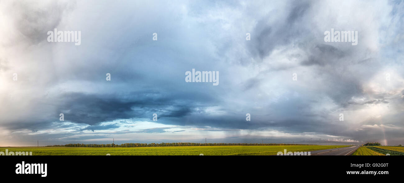 rainbow after the rain background landscape Stock Photo - Alamy