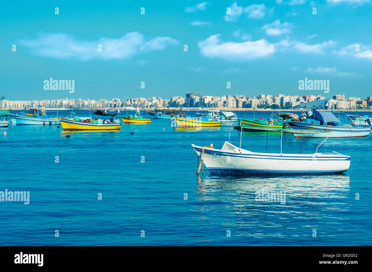 Harbor of Fishing Boats Floating on Blue Sea Water Stock Photo