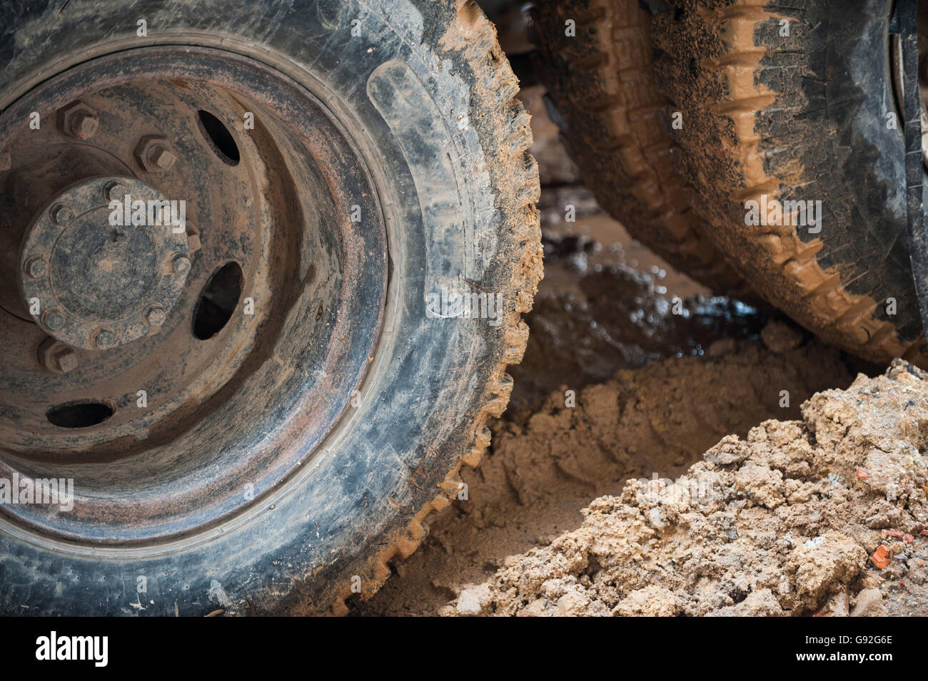 Dirty truck wheels in muddy road Stock Photo