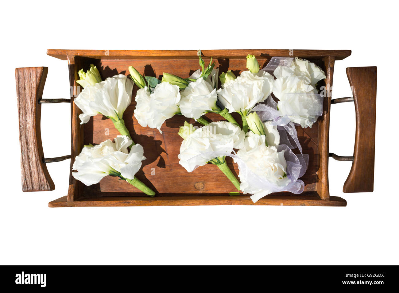 White flowers in a wooden tray isolated on white for wedding day Stock Photo