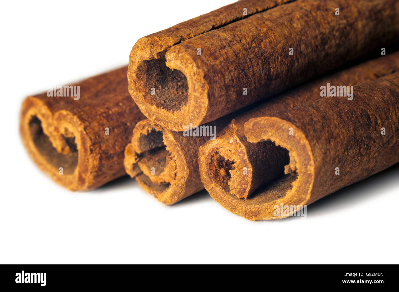 Four Cinnamon Sticks Isolated on White Background Stock Photo