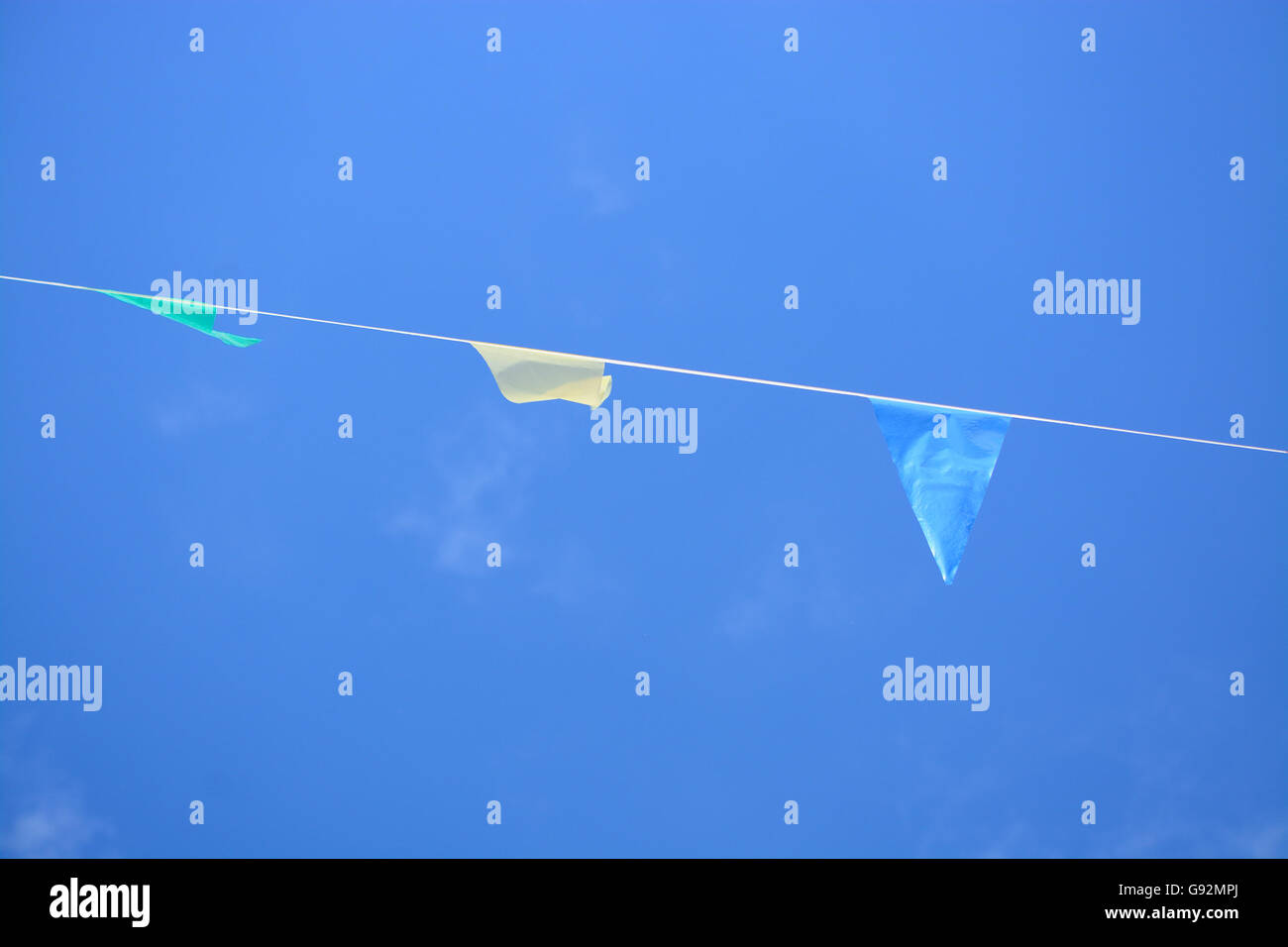 colorful party flags under a blue sky Stock Photo - Alamy