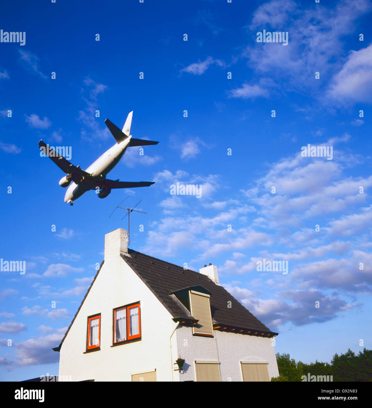 large jet aircraft on landing approach over suburban housing Stock Photo